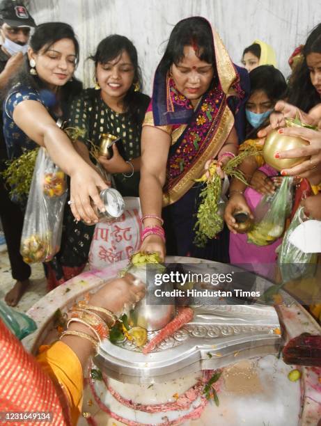 Devotees perform rituals at a temple on the occasion of Maha Shivratri festival, at Khajpura, on March 11, 2021 in Patna, India. Maha Shivratri is...