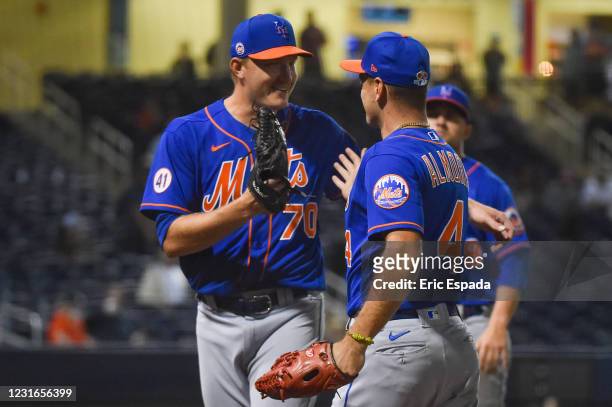 Albert Almora Jr. #4 of the New York Mets is congratulated by Mike Montgomery after his running catch during the fifth inning of the spring training...