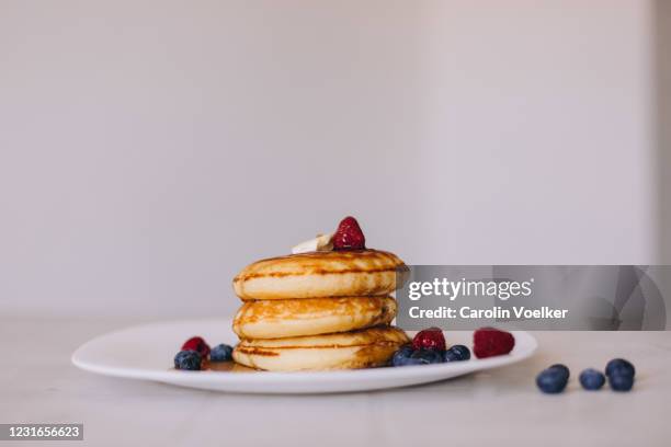 three pancakes on a white plate seen from the side - table side view stock pictures, royalty-free photos & images