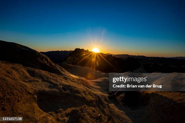 The suns sets behind the Santa Monica Mountains in a view from Eagle Rock along the Backbone Trail in Topanga State Park on Wednesday, Feb. 17, 2021...