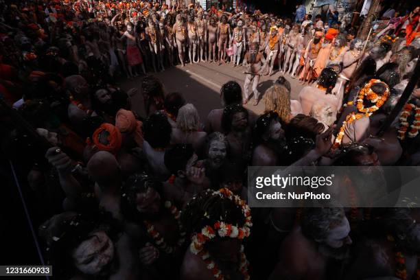 Naga Sadhus or holy men of Juna Akhara move towards ganges River to take a holy dip on the occasion of first royal bath of Shivratri festival during...