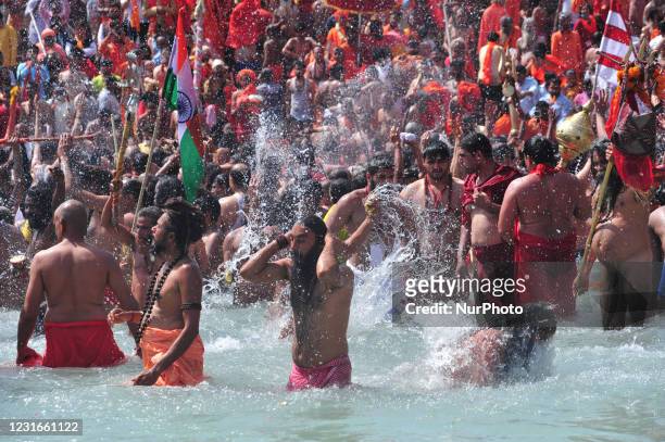 Naga Sadhus or holy man of Niranjani Akhara take a holy dip in Ganges River on the occasion of first royal bath of Shivratri festival during Maha...