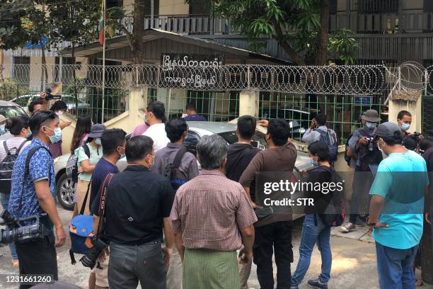 Members of the media gather outside Kamaryut Court in Yangon on March 12 as the court held a hearing in the case of Associated Press photographer...