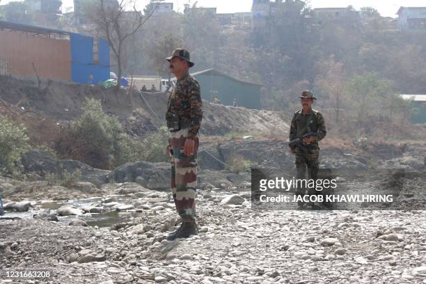 Indian army soldiers patrol along the banks of the Tiau River, a natural border between India and Myanmar, at Zokhawthar border some 50 Kms from...