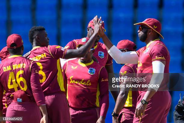 Alzarri Joseph and Kieron Pollard of West Indies celebrate the dismissal of Dimuth Karunaratne of Sri Lanka during the 2nd ODI match between West...