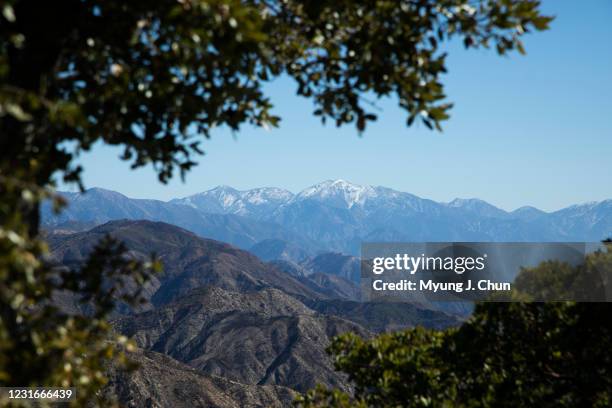 Snow-covered Mt. Baldy is visible from Mt. Disappointment Road in the San Gabriel Mountains. Multiple peaks can be hiked from Eaton Saddle, but...