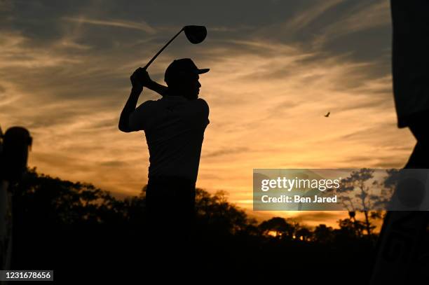 Rickie Fowler hits a shot in silhouette during the second round of THE PLAYERS Championship on THE PLAYERS Stadium Course at TPC Sawgrass on March 12...