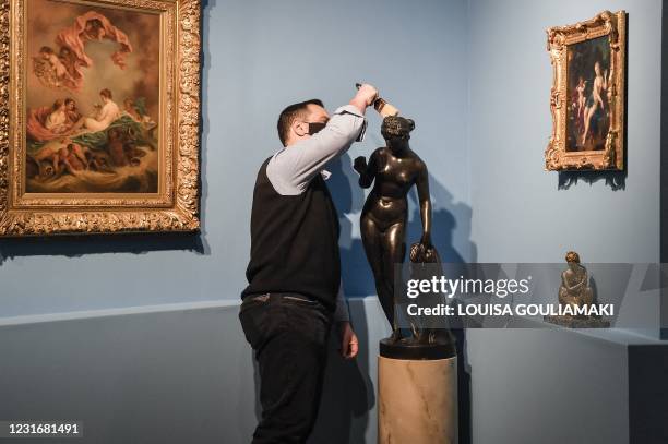 Museum employee brushes dust from a sculpture in the new museum dedicated to the Philhellene foreign volunteers who fought and died for Greece on...