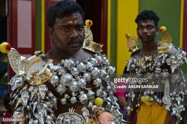 Devotees get their bodies pierced with lemon and 'Paaladai' or a utensil traditionally used to feed milk to infants, wait to take part in a religious...