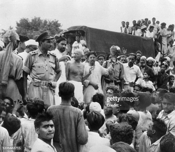 Picture taken on September 22, 1947 shows Mahatma Gandhi visiting the Muslim refugees camp of Purana Qila in New Delhi, as they prepare to depart to...