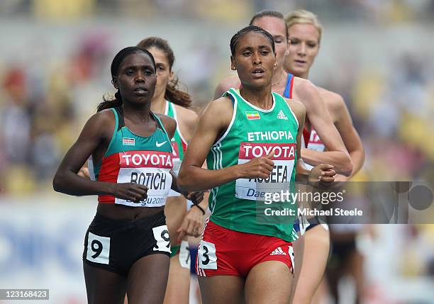Lydia Chebet Rotich of Kenya competes with Sofia Assefa of Ethiopia in the women's 3000 metres steeplechase heats during day one of the 13th IAAF...