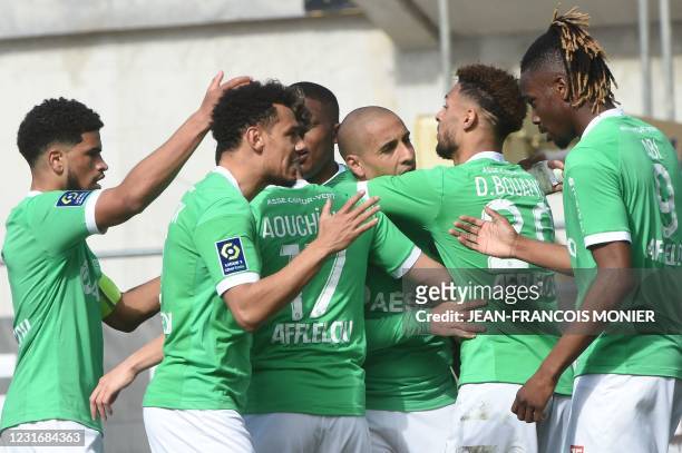 Saint-Etienne's Tunisian midfielder Wahbi Khazri is congratulated by his teammates after scoring during the French L1 Football match between Angers...
