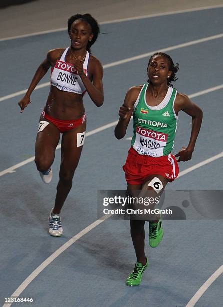 Fantu Magiso of Ethiopia and Daisurami Bonne of Cuba ccompete in the women's 400 metres heats during day one of the 13th IAAF World Athletics...