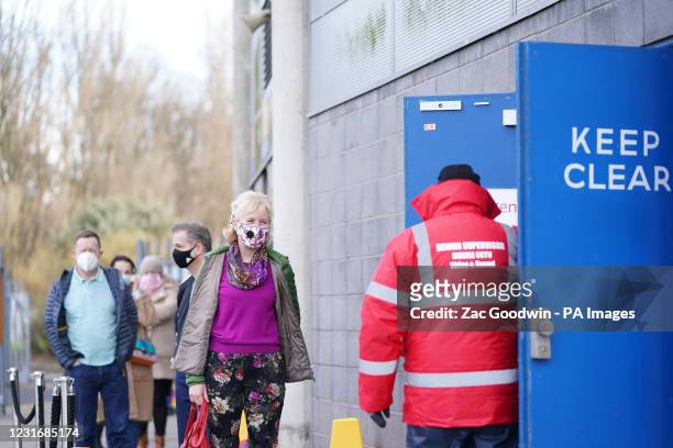 People queue to enter the ground to receive COVID-19 vaccinations before the Sky Bet League One match at KCOM Stadium, Hull.