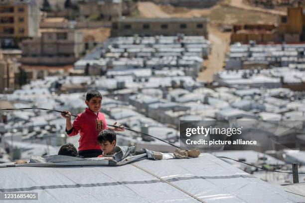 March 2021, Lebanon, Aarsal: Syrian refugee boys play at the Barra refugee camp in the Lebanese town of Aarsal, located north-east of capital Beirut....