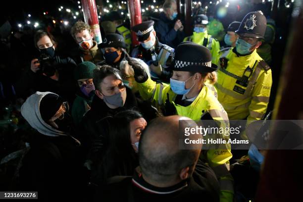 Police officers attend during a vigil for Sarah Everard on Clapham Common on March 13, 2021 in London, United Kingdom. Vigils are being held across...