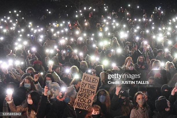 Well-wishers turn on their phone torches as they gather at a band-stand where a planned vigil in honour of alleged murder victim Sarah Everard was...