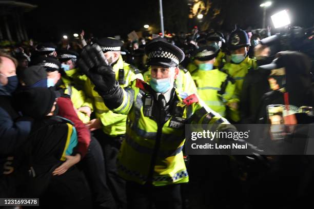 Police officers attend a vigil on Clapham Common, where floral tributes have been placed for Sarah Everard on March 13, 2021 in London, England....