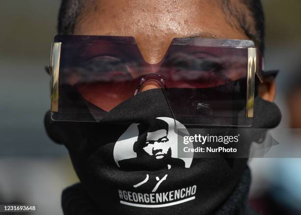 Woman wears a face mask with an image of George Nkencho outside the grounds of Sacred Heart of Jesus Church in Huntstown, Dublin, at the funeral of...