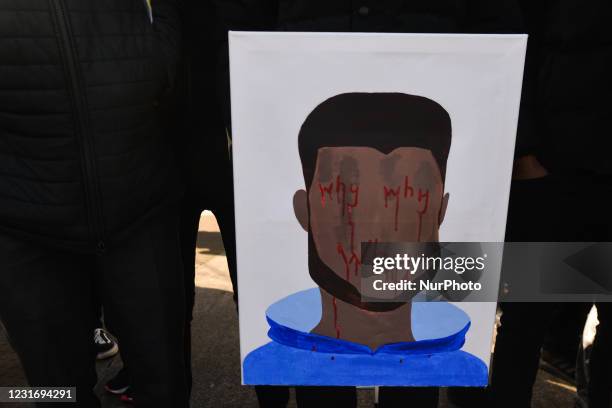 Mourners hold a poster reading 'Why Why Why' as the coffin of George Nkencho, a 27-year-old man was shot dead by Gardai outside his Dublin home last...