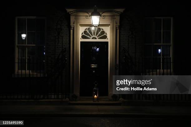 Lit candle is seen on the doorstep of 10 Downing Street on March 13, 2021 in London, United Kingdom. Vigils are being held across the United Kingdom...