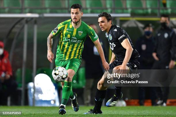 Roberto Olabe of Tondela and Joao Palhinha of Sporting in action during the Liga NOS match between CD Tondela and Sporting CP at Estadio Joao Cardoso...