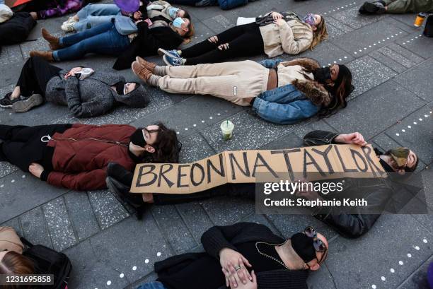 People participate in a die-in during a protest to mark the one year anniversary of Breonna Taylor's death on March 13, 2021 in New York City....