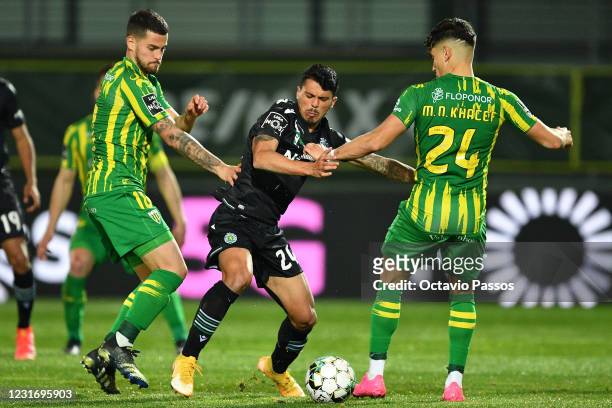 Roberto Olabe of Tondela and Pedro Porro of Sporting in action during the Liga NOS match between CD Tondela and Sporting CP at Estadio Joao Cardoso...