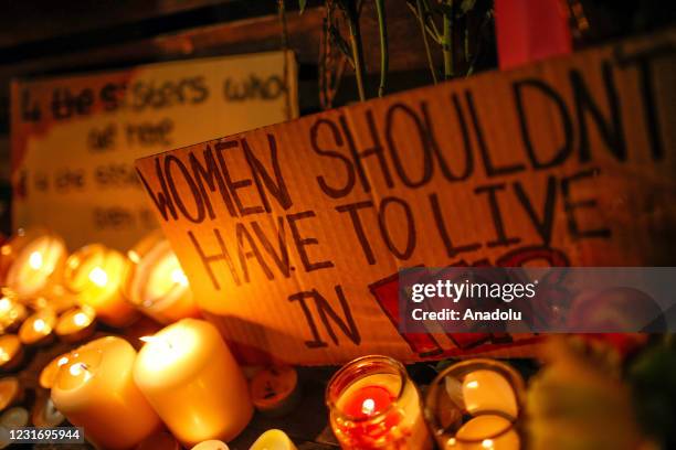 Placard rests amid candles on a bench as mourners for the life of murdered 33-year-old Sarah Everard, whose remains were found this week in woodland...