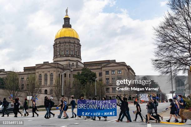 Demonstrators march through downtown in honor of Breonna Taylor on March 13, 2021 in Atlanta, Georgia. Today marks the one year anniversary of the...