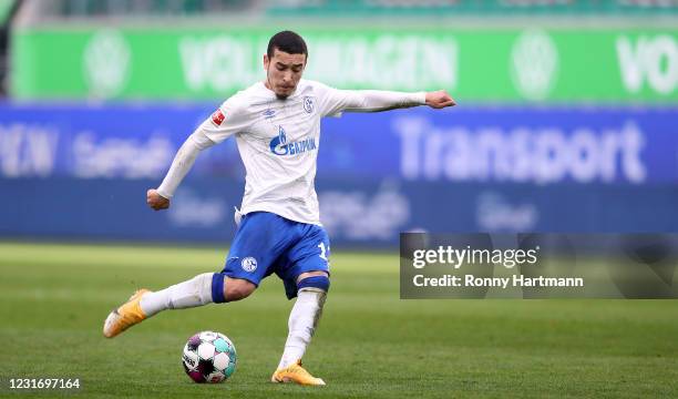 William of FC Schalke 04 kicks the ball during the Bundesliga match between VfL Wolfsburg and FC Schalke 04 at Volkswagen Arena on March 13, 2021 in...