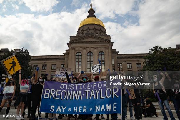 Demonstrators pose for a picture in front of the Georgia Capitol building while marching through down town in honor of Breonna Taylor on March 13,...