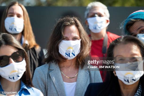 Baltimore Sun reporter Liz Bowie wears a Save Our Sun facemask with other reporters during an interview in Baltimore, Maryland on March 11, 2021. -...