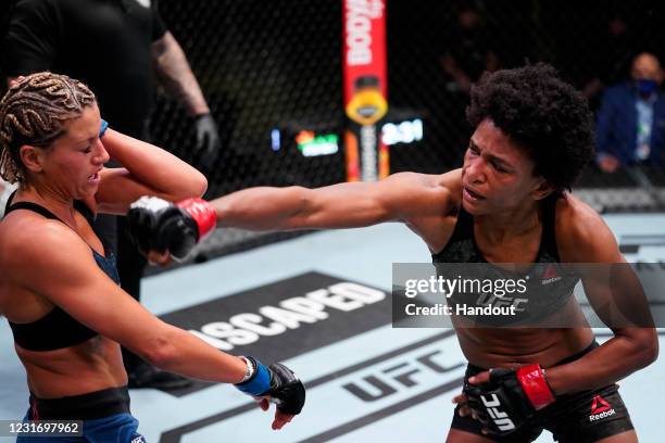 In this handout image provided by UFC, Angela Hill punches Ashley Yoder in a strawweight fight during the UFC Fight Night event at UFC APEX on March...