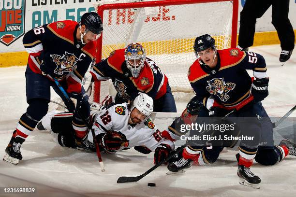 Goaltender Sergei Bobrovsky of the Florida Panthers defends the net with the help of teammates Aleksander Barkov and Noel Acciari along with Aaron...