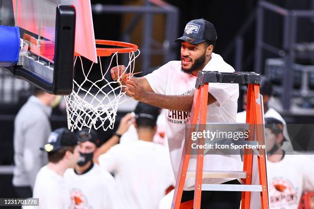 Oregon State forward Maurice Calloo cuts the net down after winning the championship game of the men's Pac-12 Tournament between the Oregon State...