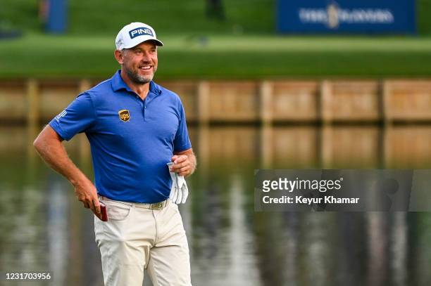 Lee Westwood of England smiles after making a birdie putt on the 17th hole green during the third round of THE PLAYERS Championship on the Stadium...