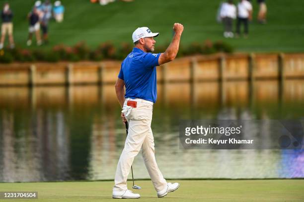 Lee Westwood of England celebrates and pumps his fist after making a birdie putt on the 17th hole green during the third round of THE PLAYERS...
