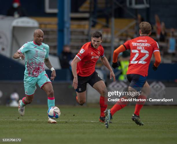 Swansea City's Andre Ayew under pressure from Luton Town's Matthew Pearson during the Sky Bet Championship match between Luton Town and Swansea City...