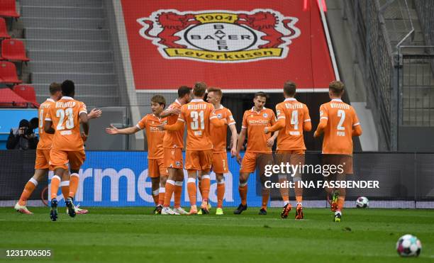 Bielefeld's Japanese forward Ritsu Doan celebrates with teammates after scoring the 0-1 during the German first division Bundesliga football match...