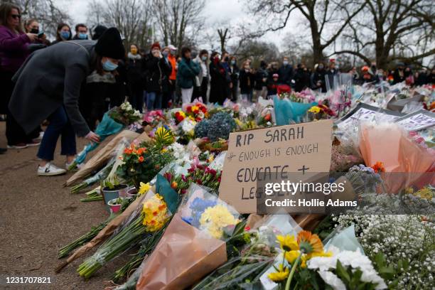 People gather to pay their respects on Clapham Common, where floral tributes have been placed for Sarah Everard on March 14, 2021 in London, England....