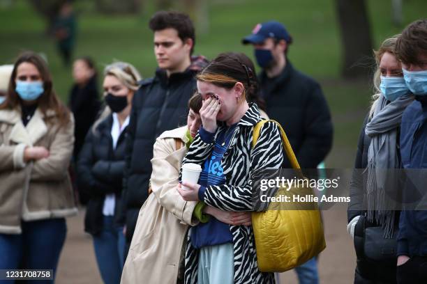 Woman cries as she pays her respects on Clapham Common, where floral tributes have been placed for Sarah Everard on March 14, 2021 in London,...
