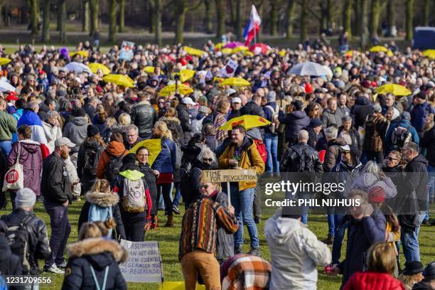 People gather in the Hague, on March 14 during a rally to protest government restrictions aimed at stopping the spread of the coronavirus. -...