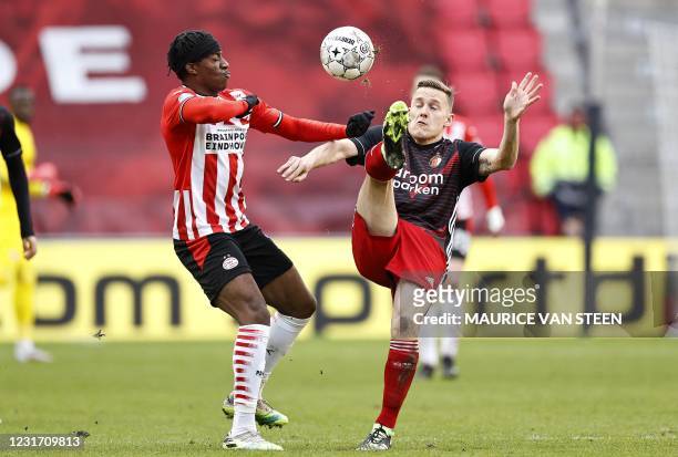 Eindhoven English forward Noni Madueke fights for the ball against Feyenoord Dutch midfielder Jens Toornstra during the Dutch Eredivisie match...