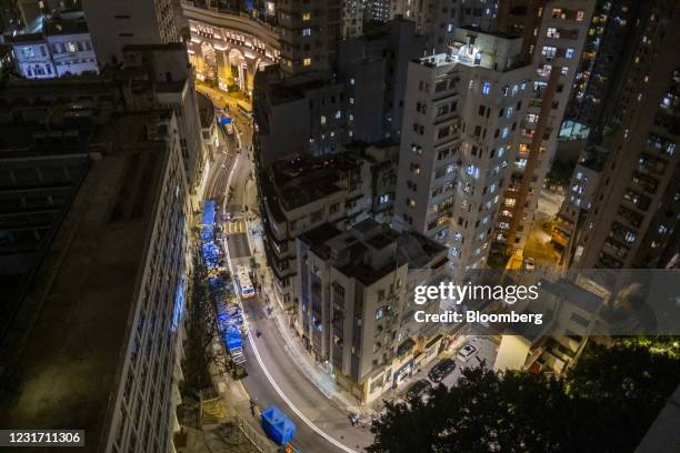 Tents are set up in an area under lockdown on Pok Fu Lam Road in the Sai Ying Pun neighborhood of Hong Kong, China, on Sunday, March 14, 2021. Hong...