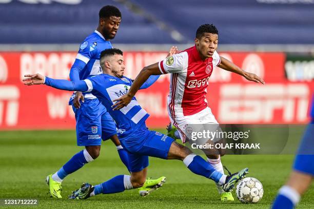 Zwolle's Dutch defender Kenneth Paal and team mate Dutch midfielder Mustafa Saymak fight for the ball against Ajax's Brazilian forward David Neres...