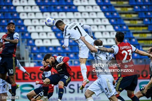 Juventus' Portuguese forward Cristiano Ronaldo heads the ball to open the scoring during the Italian Serie A football match Cagliari vs Juventus on...