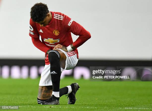Manchester United's English striker Marcus Rashford takes a knee against racism ahead of the English Premier League football match between Manchester...