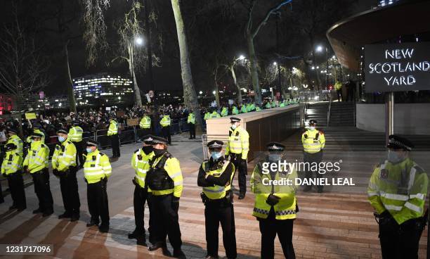 Police officers form a cordon at New Scotland Yard, the headquarters of the Metropolitan Police Service, in central London on March 14, 2021 as...