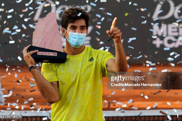 Cristian Garin of Chile celebrates with the trophy after winning the match against Facundo Bagnis of Argentina during the final of Chile Dove...